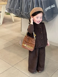 Close-up of children's brown corduroy vest set with stylish quilted pearl chain handbag