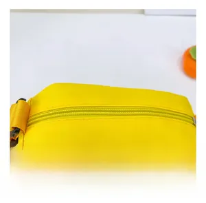 Detail shot of the yellow canvas bag showing top zipper and white GAME lettering