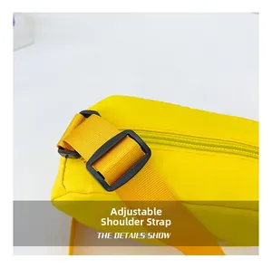 Detail view of adjustable plastic buckle and bright yellow canvas strap for kids' crossbody bag