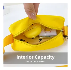 Internal capacity of yellow canvas crossbody bag showing phone and accessories