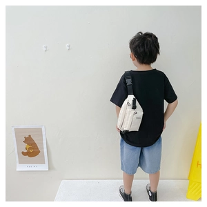 Παιδική τσάντα στήθους από καμβά σε off-white χρώμα με ρυθμιζόμενη αγκράφα σε μοντέλο