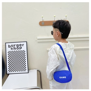 Close-up of blue canvas crossbody bag for kids with white GAME letter print on front