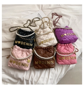 Detailed view of quilted bucket bags in six colors with pearl handles and gold logos