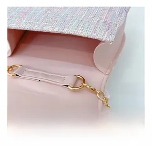 Detailed close-up of pink sequin handbag showing gold metal chain and inner lining