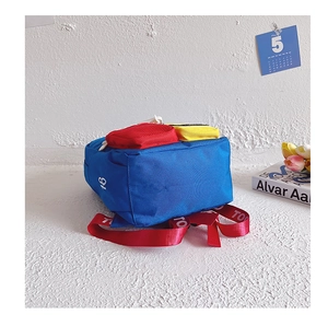 Detail of blue and red contrast color kindergarten backpack with letter printed straps