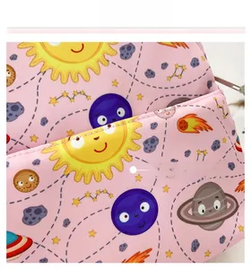 Close-up of pink fabric featuring cute cartoon space theme patterns with stars and planets