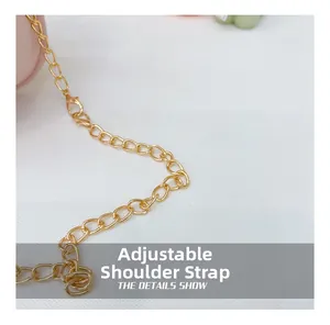Detail view of the adjustable golden metal chain strap with lobster clasp for girl bags