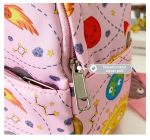 Macro detail of smooth metal zipper puller on a pink cartoon space theme backpack