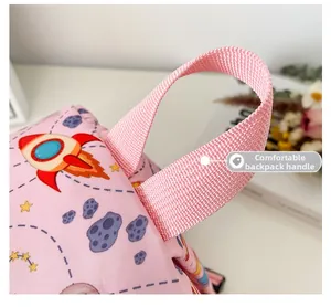 Close-up of pink toddler backpack showing thick nylon handle and space rocket patterns