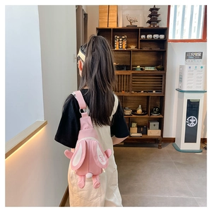 Détail du sac bandoulière lapin rose en toile avec broderie Love sur les oreilles