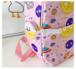 Detailed view of the convenient side pocket on kids pink space print backpack