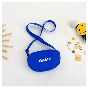 Close-up of blue nylon crossbody bag with GAME text and decorative kid-friendly patches