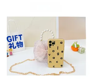 Pink sequin mini bag with bow and pearl handle next to a phone case for size reference