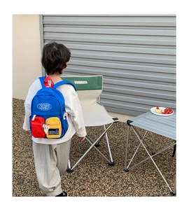 Close-up of durable canvas kids backpack with vibrant blue, red and yellow color-blocking