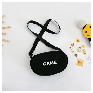 Detail of black canvas oval crossbody bag with white GAME text and adjustable strap