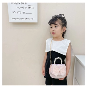 Girl's pink princess handbag with large tulle bow, pearl handle, and gold chain strap detail