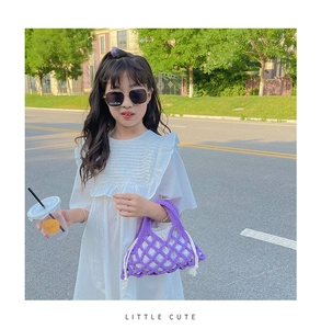 Close-up of purple hand-woven mesh bucket bag with drawstring liner for kids