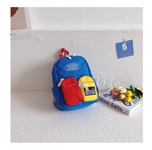 Detail of vibrant color-block toddler backpack with blue canvas and contrast red zip pocket