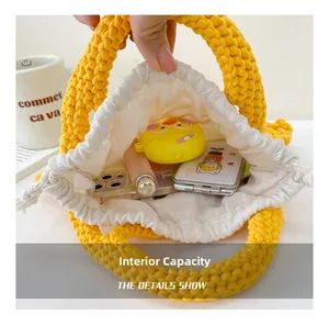 Detail view of the spacious inner lining for yellow crochet bucket bag showing capacity