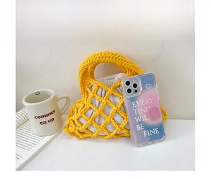 Detail of yellow woven hollow bucket bag with cream drawstring inner pouch for kids