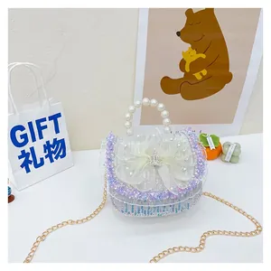 Detail of princess glitter mini bag with pearl handle and yellow lace bow decoration