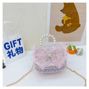 Detail of pink woven tweed girl's handbag with sequin mesh bow and pearl handle