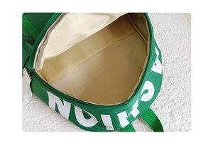 Detail view of the green canvas backpack's main inner compartment and white lining