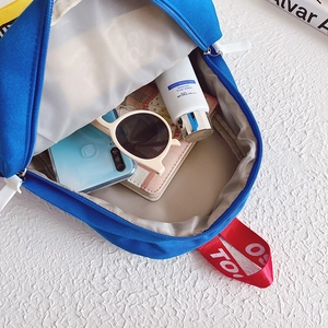 Kids blue canvas backpack with color-block straps showing spacious main compartment