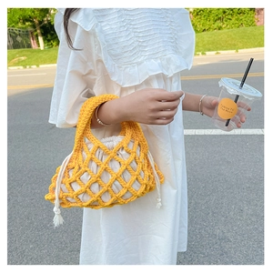 Detailed shot of yellow hand-woven hollow bucket bag with white drawstring lining