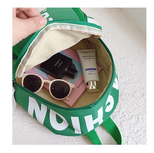 Detail view of the green canvas backpack interior showing ample storage for daily items