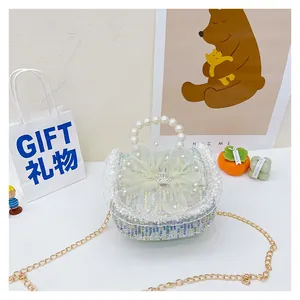 Detail of sequin woven kids purse with pearl handle, mesh bow and crown charm
