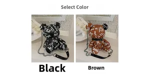 Detailed comparison of black and brown graffiti bear crossbody bags with chain straps
