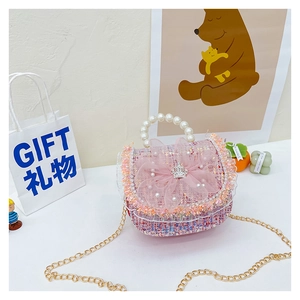 Detail of pink tweed girl handbag with pearl handle and mesh flower decoration