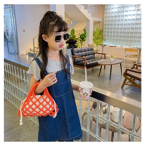 Detail of orange woven mesh bucket bag with white drawstring liner for children