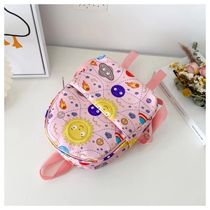 Detail of pink kids backpack with cute cartoon space patterns and durable shoulder straps