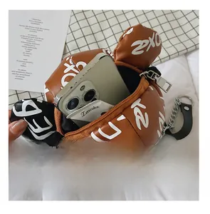 Internal view of brown bear-shaped graffiti bag showing phone storage and silver zipper