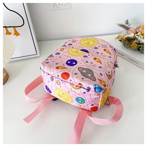 Detail of pink toddler backpack with cartoon space planet patterns on canvas fabric