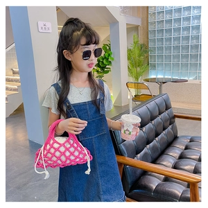 Pink crochet bucket bag detail paired with a casual denim dress and accessories