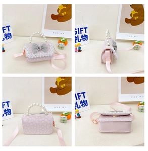 Detail of pink lace kids bag with pearl handle and rhinestone bow decoration