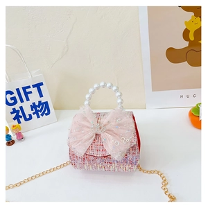 Detail of pink tweed children purse with pearl handle and lace bow decoration