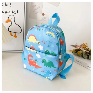 Detailed close-up of sky blue cartoon dinosaur backpack on an aesthetic desktop