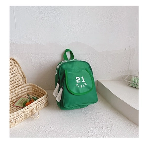 Detail of green canvas kids backpack featuring white number 21 and fashion lettering print