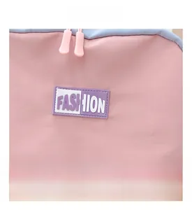 Detailed view of pink and blue canvas backpack with Fashion logo and premium zipper