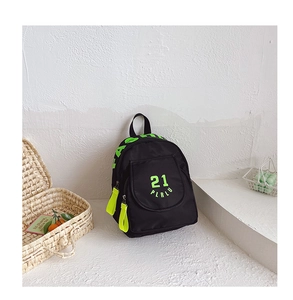 Detail view of black canvas backpack with fluorescent green zipper pull and art lettering