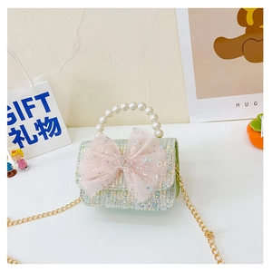 Detail view of tweed mini crossbody bag with sequin bow, pearl handle and gold chain strap