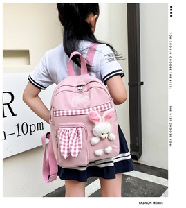 Pink waterproof nylon kids backpack featuring cute plush bunny and plaid pocket detail