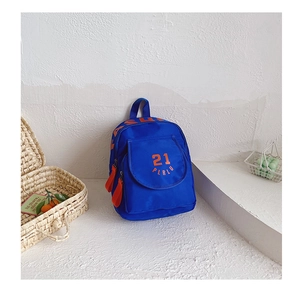 Detail of blue canvas school backpack with orange zippers and front printed pocket