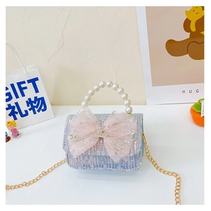 Detail of pink and blue tweed kids purse with sequin bow, pearl handle and gold chain