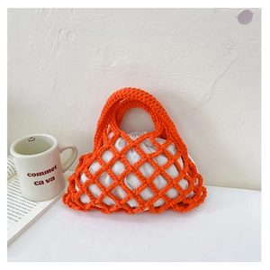 Close-up of bright orange hand-woven mesh bucket bag with white drawstring lining