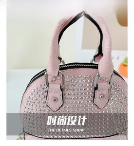 Detailed view of the pink mini shell bag with sparkling rhinestones and metal chain handle